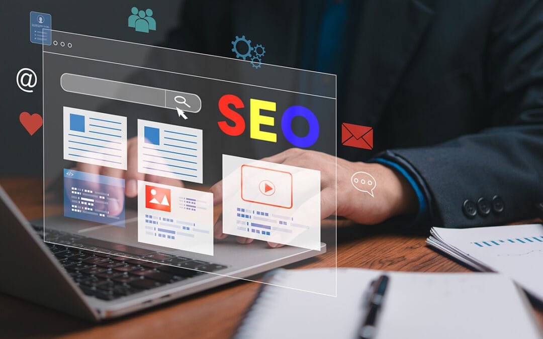 A man is typing on a laptop with a screen displaying a website with the words SEO on it